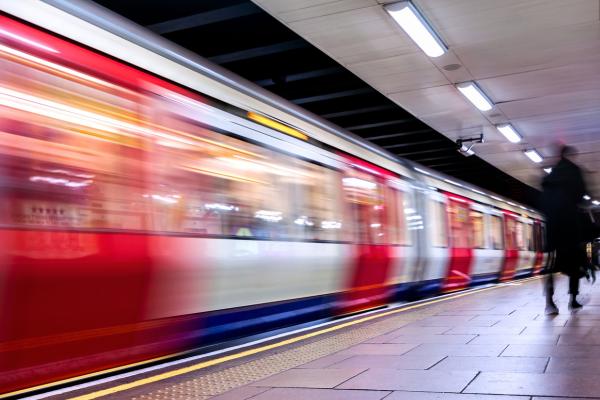 Person waiting for train featuring our article on "How the Elizabeth Line has improved transport links to Slough"